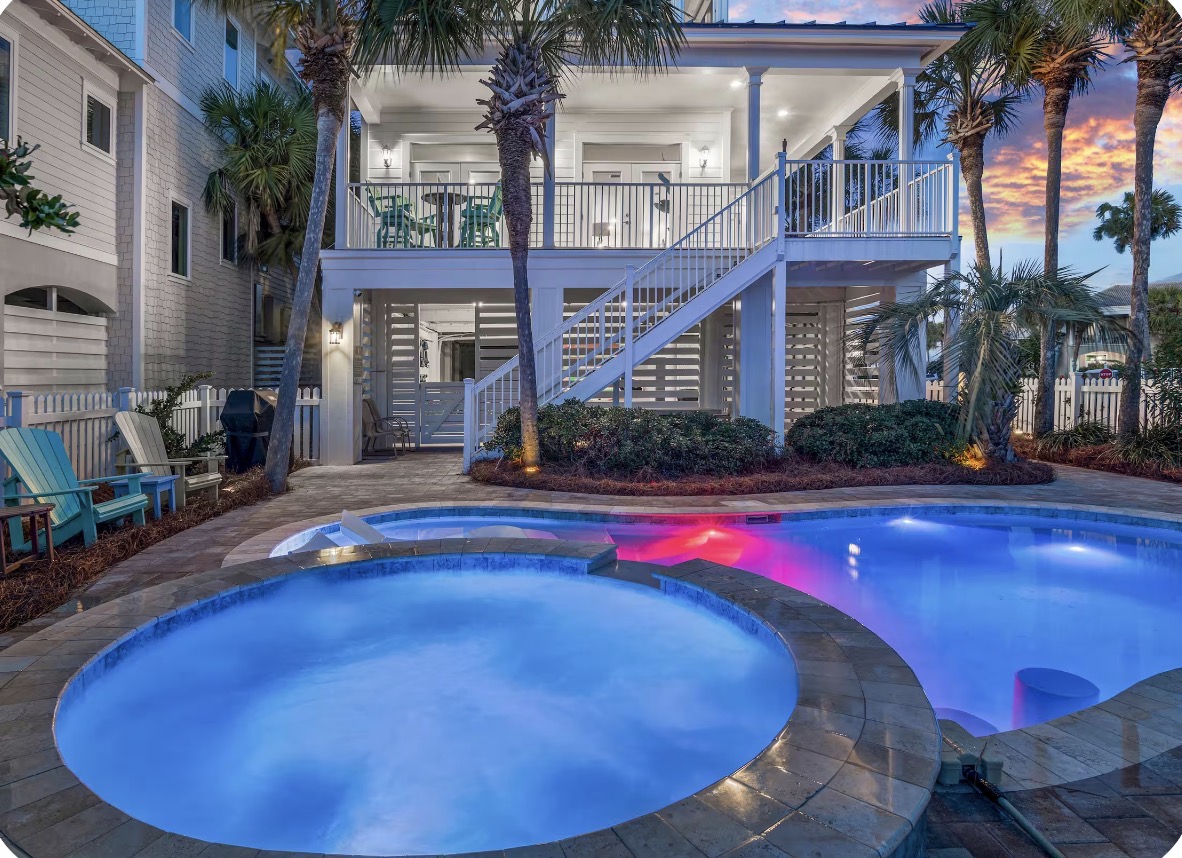Circular hot tub and private pool at twilight at this Destin private pool vacation rental
